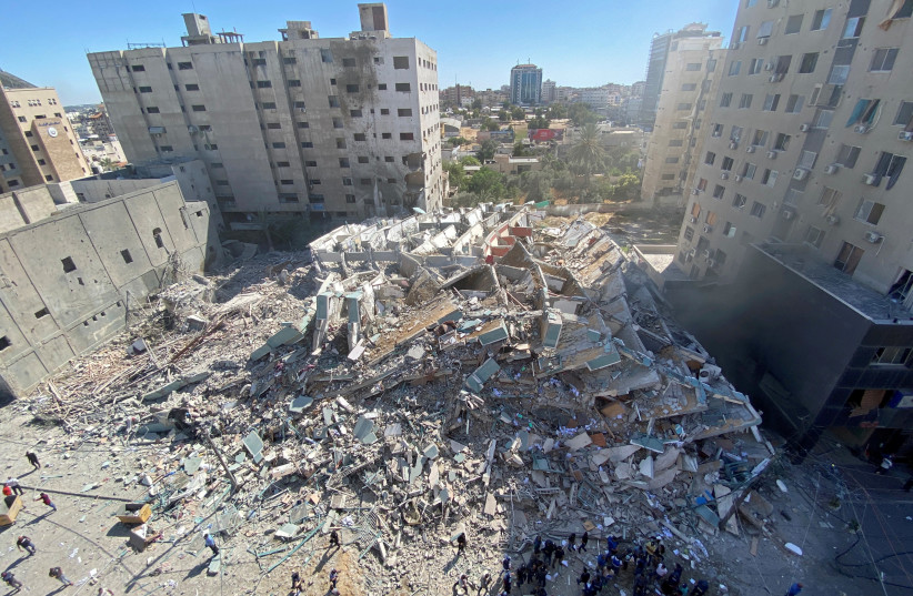 A tower housing AP, Al Jazeera offices collapses after Israeli missile strikes in Gaza city, (photo credit: REUTERS/MOHAMMED SALEM)