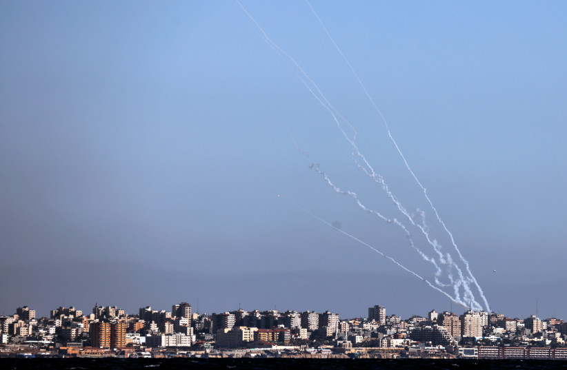 Rockets launched from the Gaza strip towards Israel as it seen from an Israeli naval boat while patrolling in the Mediterranean Sea off the southern Israeli coast as Israel-Gaza fighting rages on May 19, 2021. (photo credit: AMIR COHEN/REUTERS)