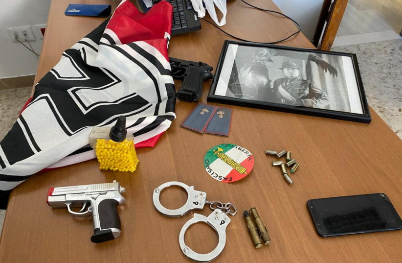 An Italian police handout photo shows weapons, Nazi flags and a picture of dictator Benito Mussolini from the homes of members of a far-right movement celebrating white supremacism and allegedly trying to build a new fascist party, during an operation carried out in 18 Italian provinces, in Italy, M (photo credit: POLIZIA DI STATO/HANDOUT VIA REUTERS)