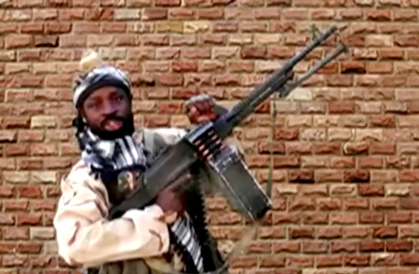 Boko Haram leader Abubakar Shekau holds a weapon in an unknown location in Nigeria in this still image taken from an undated video obtained on January 15, 2018. (photo credit: BOKO HARAM HANDOUT/SAHARA REPORTERS VIA REUTERS)
