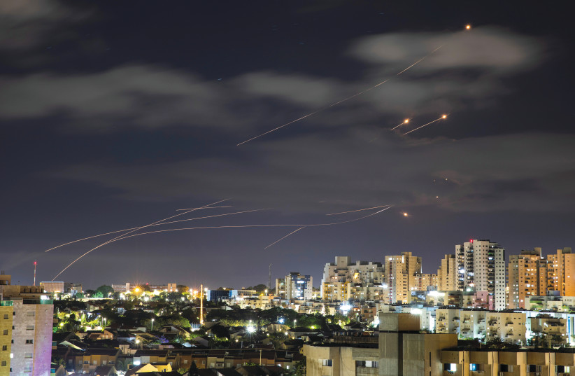 Streaks of light are seen from Ashkelon as the Iron Dome system intercepts rockets launched from the Gaza Strip at Israel on May 17 (credit: AMIR COHEN/REUTERS)