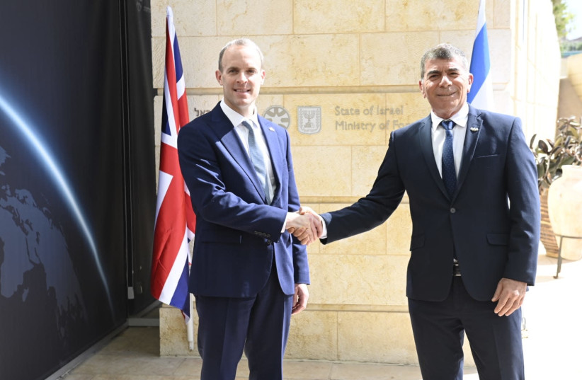 Foreign Minister Gabi Ashkenazi is seen with UK Foreign Secretary Dominic Raab in Jerusalem, Israel, on May 26, 2021. (photo credit: JORGE NOVOMINSKY/FOREIGN MINISTRY)