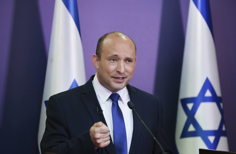 Yamina leader Naftali Bennett announces that he will form a unity government with Yesh Atid leader Yair Lapid., May 30, 2021. (photo credit: YONATAN SINDEL/FLASH 90)