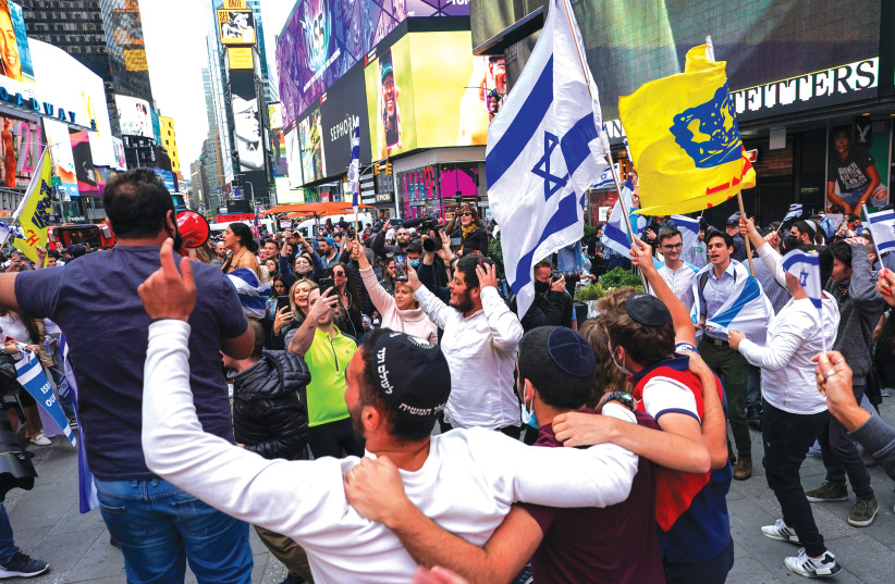 DEMONSTRATORS DANCE at a pro-Israel rally at Times Square in New York City, earlier this month. (photo credit: REUTERS/DAVID 'DEE' DELGADO)