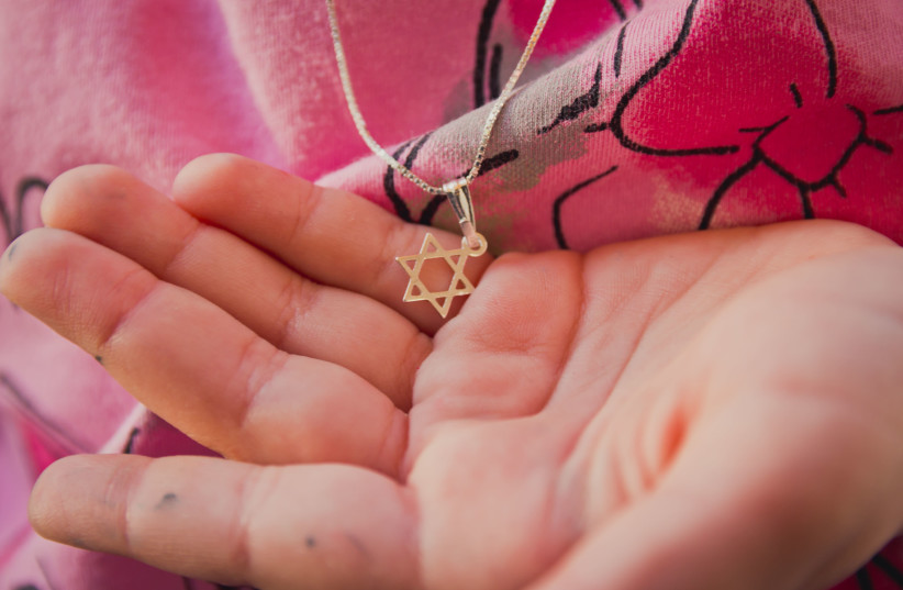 Jewish star necklaces are a signifier of Jewish identity and, some fear, a potential risk during times of antisemitism. (photo credit: GETTY IMAGES/JTA)