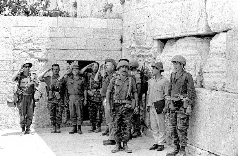 IDF SOLDIERS stand at the Western Wall in June 1967 after it was captured during the Six Day War. (photo credit: DEFENSE MINISTRY/REUTERS)