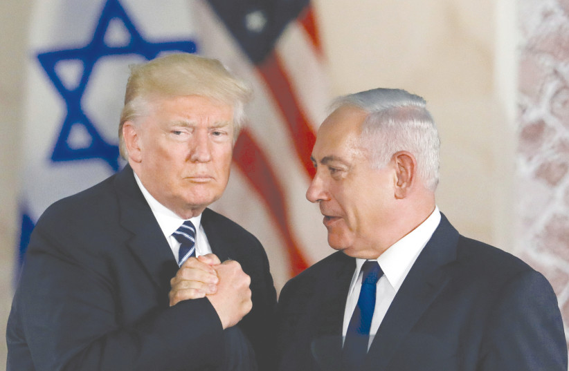 FORMER PRESIDENT Donald Trump and Prime Minister Benjamin Netanyahu shake hands at the Israel Museum in Jerusalem in 2017. (photo credit: RONEN ZVULUN/REUTERS)