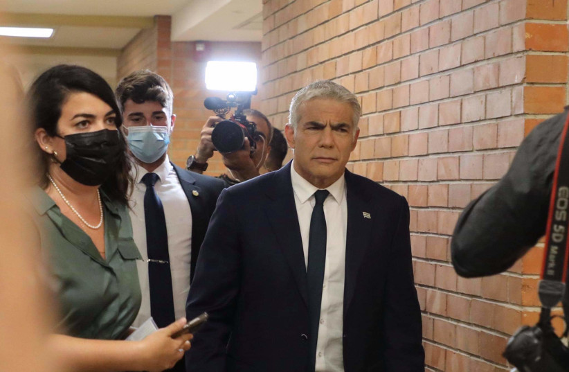 YAIR LAPID arrives at the Knesset ahead of the vote and swearing in of the 36th government, June 13, 2021. (photo credit: MARC ISRAEL SELLEM/THE JERUSALEM POST)