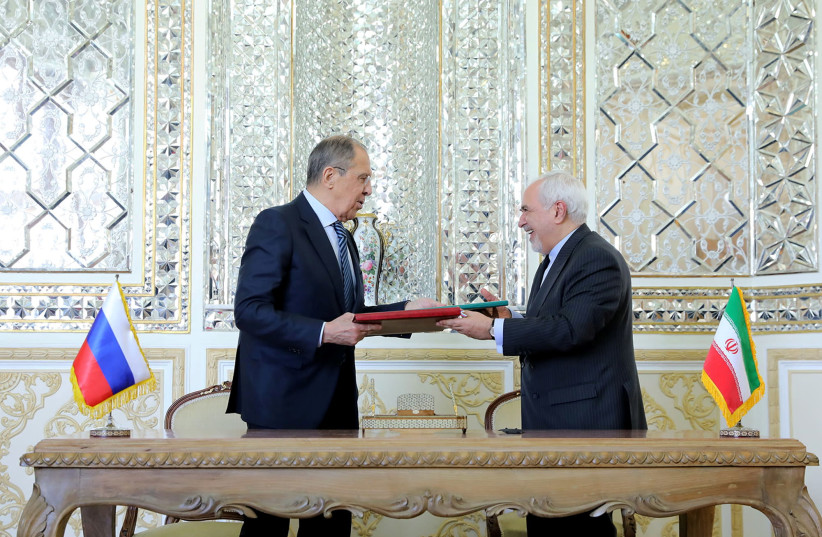 Iran's Foreign Minister Mohammad Javad Zarif and Russia's Foreign Minister Sergey Lavrov are seen during a signing ceremony, in Tehran, Iran, April 13, 2021. (photo credit: IRAN'S FOREIGN MINISTRY/WANA (WEST ASIA NEWS AGENCY)/HANDOUT VIA REUTERS)