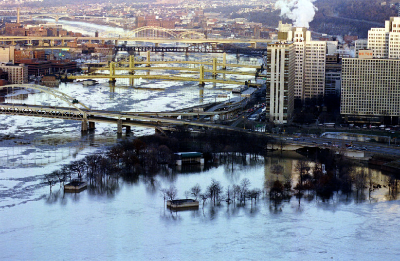 DOWNTOWN PITTSBURGH, where the author finds herself stuck despite wanting to live in Israel, lies underwater from flooding of the Allegheny River (top)  and Monongahela River, 1995. (photo credit: REUTERS)