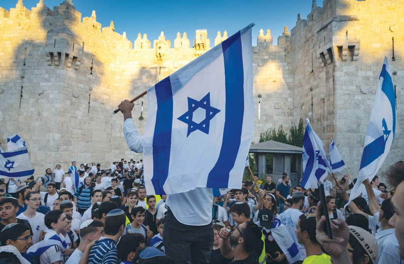 PARTICIPANTS DANCE outside Damascus Gate during the flag march in Jerusalem on Tuesday. (photo credit: OLIVIER FITOUSSI/FLASH90)