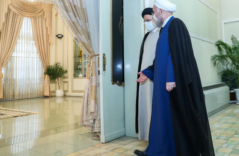 Iran's outgoing President Hassan Rouhani meets with Iran's President-elect Ebrahim Raisi in Tehran, Iran June 19, 2021. (credit: OFFICIAL PRESIDENT WEBSITE/HANDOUT VIA REUTERS)