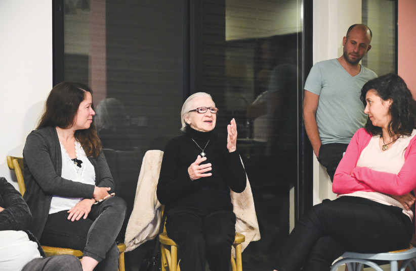 HOLOCAUST SURVIVOR Rivka Yaari tells her story during a salon meeting as part of the ‘Zikaron Basalon’ project, on the eve of Holocaust Remembrance Day, in Moshav Kidmat Tzvi, in April. ( (credit: MICHAEL GILADI/FLASH90)