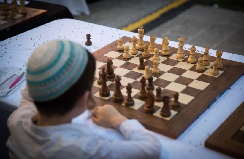 Israeli chess players take part in a special chess tournament marking Israel's 70th anniversary at Jaffa Gate in Jerusalem's Old City, April 30, 2018. (credit: YONATAN SINDEL/FLASH 90)