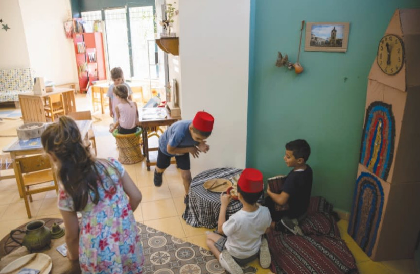 CHILDREN PLAY in a classroom at Hand in Hand, a mixed Jewish-Arab kindergarten, in Jaffa. (photo credit: RONEN ZVULUN/REUTERS)