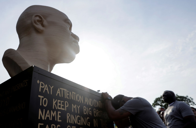 Terrence Floyd, brother of the late George Floyd who was killed by a police officer, reacts during the unveiling event of Floyd's statue, as part of Juneteenth celebrations, in Brooklyn, New York, US, June 19, 2021. (photo credit: JEENAH MOON/REUTERS)
