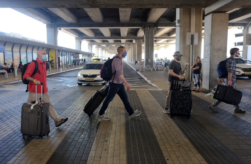 ourists walk at the Ben Gurion International Airport after entering Israel by plane, as coronavirus disease (COVID-19) restrictions ease, in Lod, near Tel Aviv, Israel (credit: RONEN ZVULUN/ REURERS)