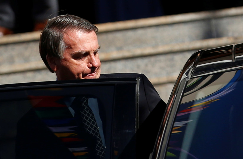 Brazil's President Jair Bolsonaro gets in a vehicle after attending Mass at a Catholic church in Brasilia, Brazil July 1, 2021. (credit: ADRIANO MACHADO/ REUTERS)