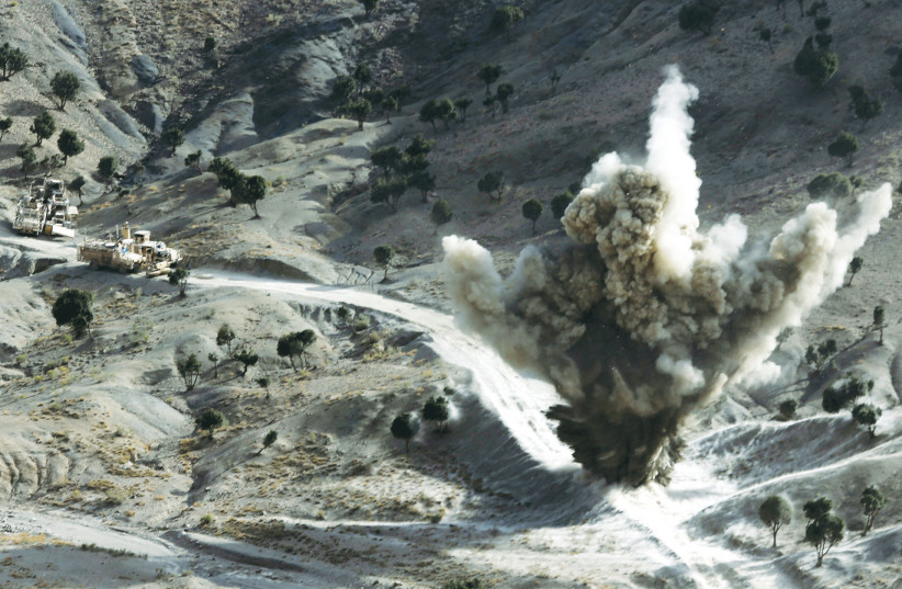US SOLDIERS explode a roadside bomb set by Taliban fighters in Paktika Province, Afghanistan, near the Pakistani border, in 2012. (credit: GORAN TOMASEVIC/REUTERS)