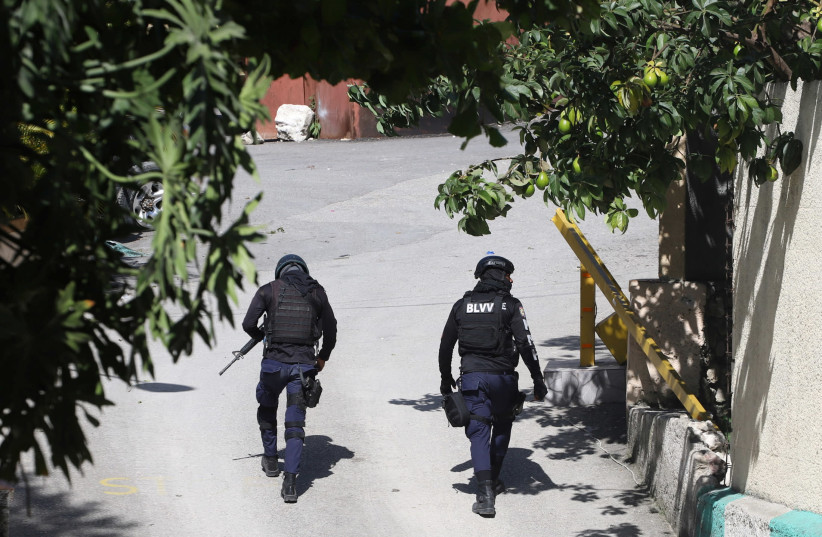 Police officers walk near the private residence of Haiti's President Jovenel Moise after he was shot dead by gunmen with assault rifles, in Port-au-Prince, Haiti July 7, 2021.  (credit: REUTERS/ESTAILOVE ST-VAL)