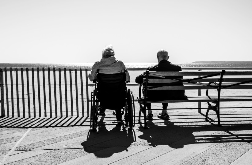 Illustrative photo of two elderly people staring at a beach.  (photo credit: BRUNO AGUIRRE/UNSPLASH)