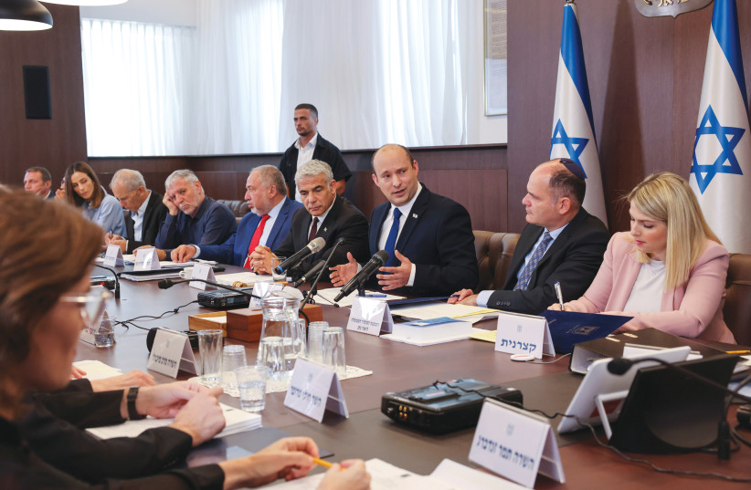 PRIME MINISTER Naftali Bennett speaks as he chairs the first weekly cabinet meeting of his new government in Jerusalem last month. (photo credit: EMMANUEL DUNAND/REUTERS)