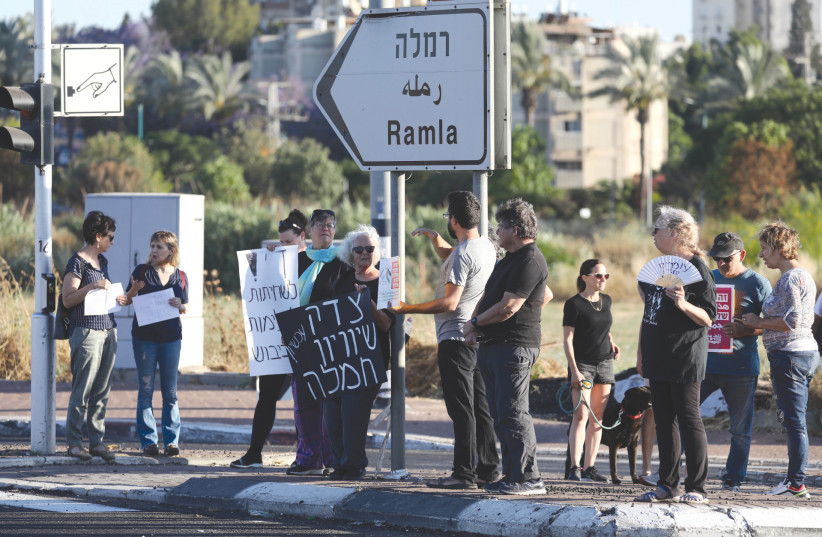Jews and Arabs protest together for calm and coexistence in Lod, following a night of heavy rioting by Arab residents, in May. (credit: YOSSI ALONI/FLASH90)