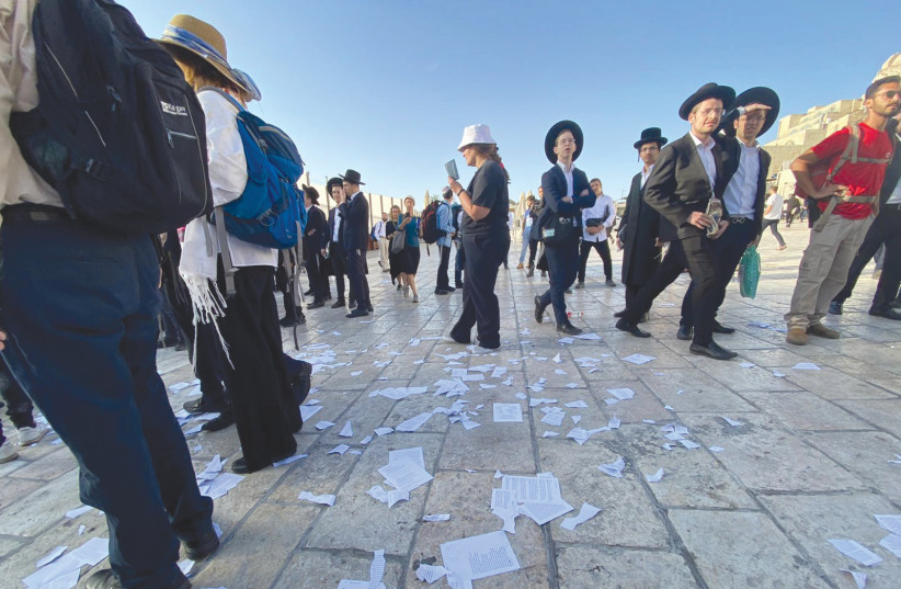 On June 11, at the Western Wall, 39 Women of the Wall prayer books were grabbed, torn up, and destroyed.  (credit: WOMEN OF THE WALL)