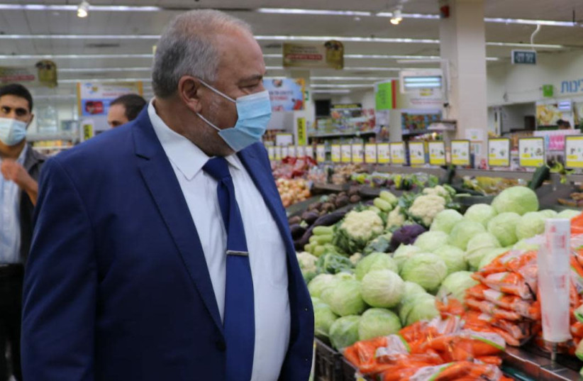 Finance Minister Avigdor Liberman checks food prices at a Jerusalem supermarket. (photo credit: Courtesy)