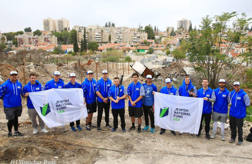 Team Israel holds up Jewish National Fund-USA banners at the JNF-USA Project Baseball field under construction in Beit Shemesh (photo credit: ISRAEL BASEBALL ASSOCIATION)