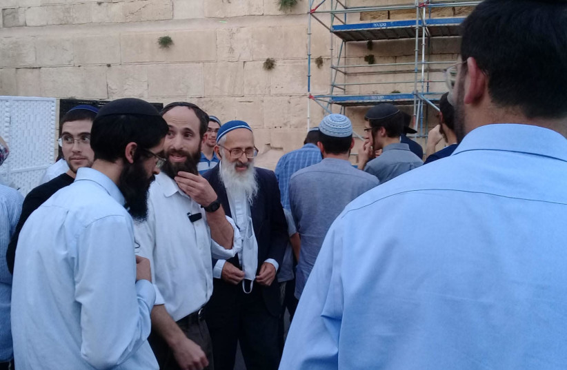 Prominent leader of the hardline religious-Zionist community Rabbi Shlomo Aviner is present Thursday night when a group of Orthodox activists interrupted a Masorti (Conservative) celebration at the egalitarian section of the Western Wall. (credit: MASORTI MOVEMENT IN ISRAEL)