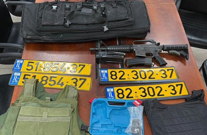 Weapons, body armor and fake license plates seized from residents of Nazareth by Israel Police during undercover activity. (credit: ISRAEL POLICE)