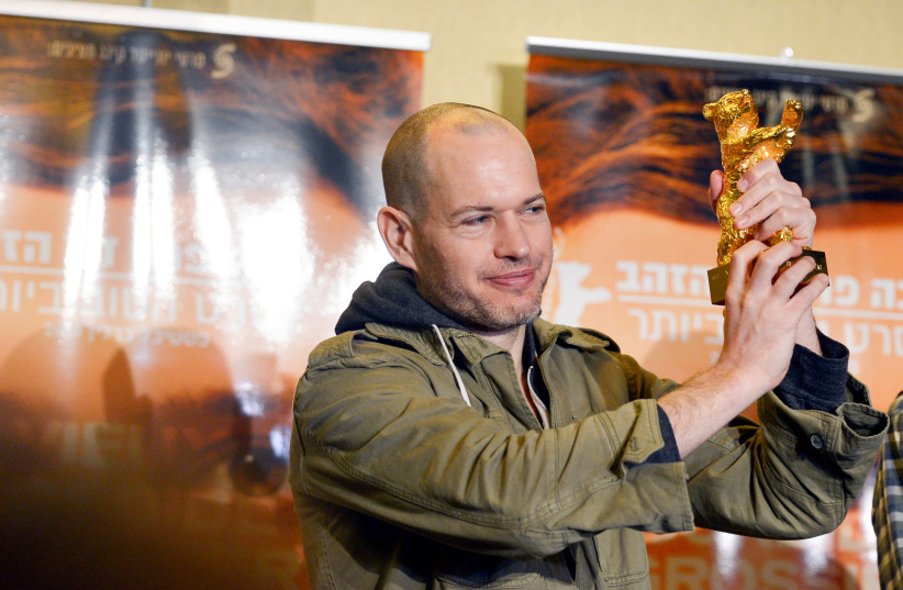 Israeli director Nadav Lapid holds his Golden bear for best film for 'Synonyms', during a press conference at the Ben Gurion international airport near Tel Aviv (photo credit: FLASH90)