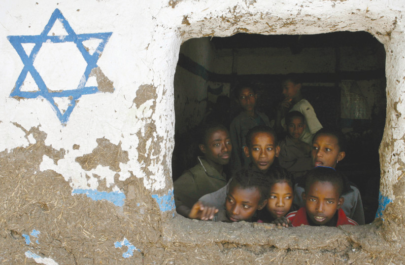 ETHIOPIAN CHILDREN, whose roots trace back to Judaism, look out of a window at a Beta Israel school while awaiting immigration to Israel, in Gondar in 2007.  (photo credit: ELIANA APONTE/REUTERS)