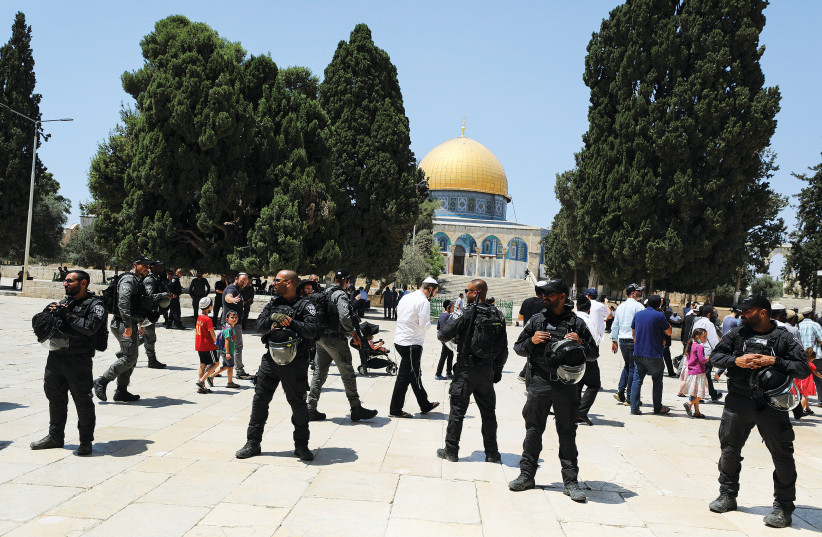 SECURITY FORCES guard the safety of Jewish visitors to the Temple Mount during Tisha Be’av, on Sunday (photo credit: AMMAR AWAD / REUTERS)
