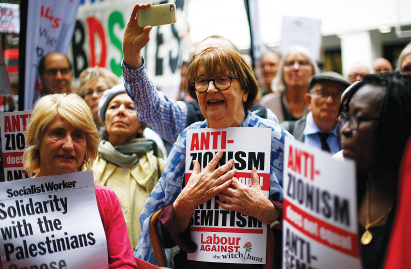 SUPPORTERS OF Britain’s Labour Party take part in protests outside a meeting of its National Executive, which was discussing the party’s definition of antisemitism, in London in 2018 (photo credit: HENRY NICHOLLS/REUTERS)
