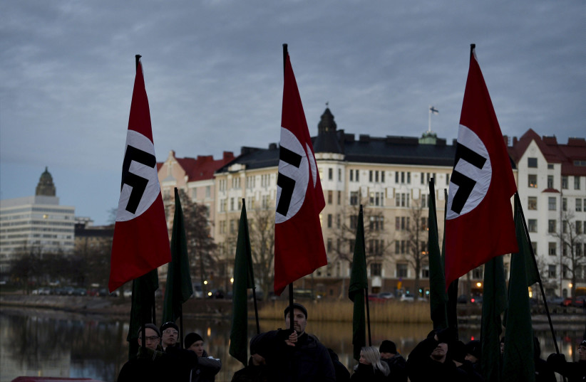 Finnish neo-nazis start their Independence Day march with swastika flags in Helsinki, Finland December 6, 2018 (credit: MARTTI KAINULAINEN/LEHTIKUVA/VIA REUTERS)