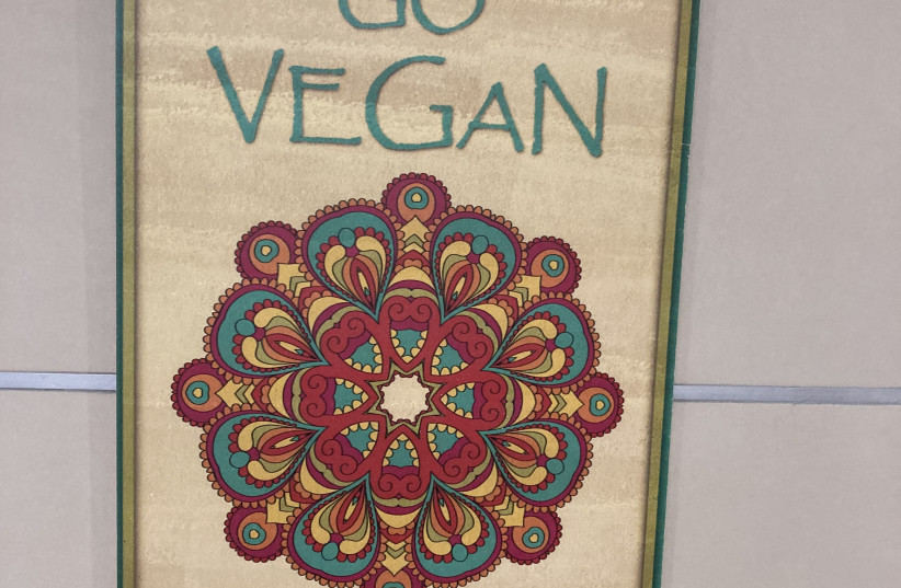 A poster advocating veganism outside the writer’s apartment at Protea Hills in Shoresh. (photographer: Courtesy)