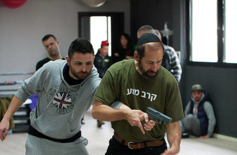 Katz demonstrates Krav Maga with a colleague.  ‘We rely on sound techniques and the natural body movement.’ (photographer: Courtesy)