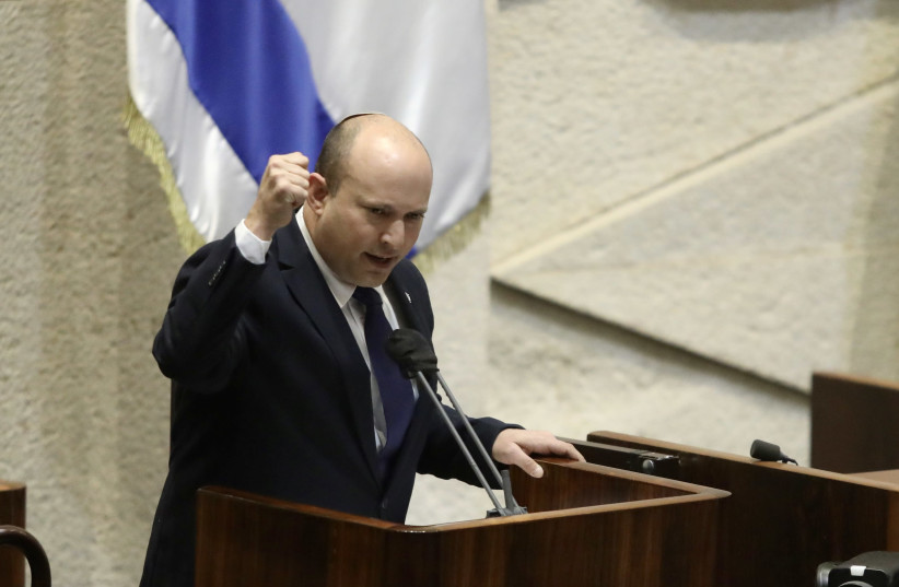 NAFTALI BENNETT gestures at the podium in Knesset, August 2, 2021 (photo credit: MARC ISRAEL SELLEM)
