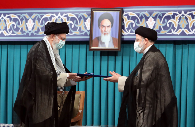  Iran's new President Ebrahim Raisi receives the endorsement decree for his presidency from Iran's Supreme Leader Ayatollah Ali Khamenei, in Tehran, Iran August 3, 2021. (credit: OFFICIAL KHAMENEI WEBSITE/HANDOUT VIA REUTERS)