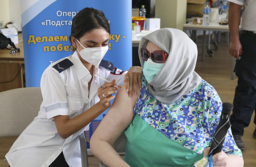  Third vaccine doses being administered at the Amigdor Retirement Residence by Magen David Adom (MDA), Jerusalem, August 5, 2021.  (credit: MARC ISRAEL SELLEM)