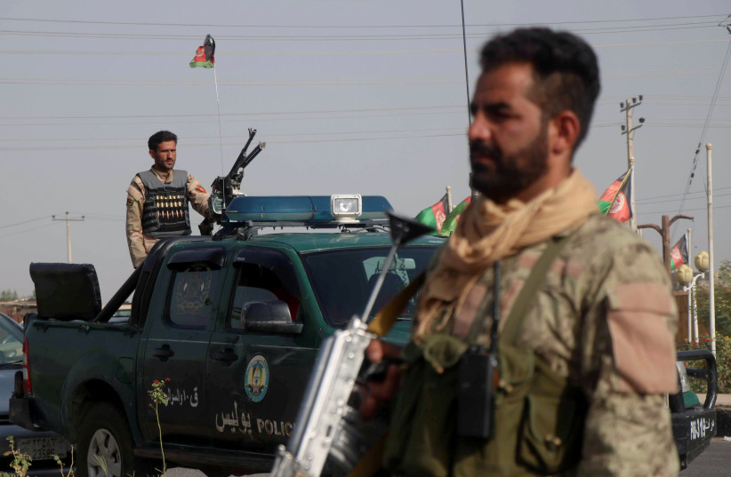 Afghan security forces keep watch at a checkpoint in the Guzara district of Herat province, Afghanistan July 9, 2021.  (credit: JALIL AHMAD/REUTERS)