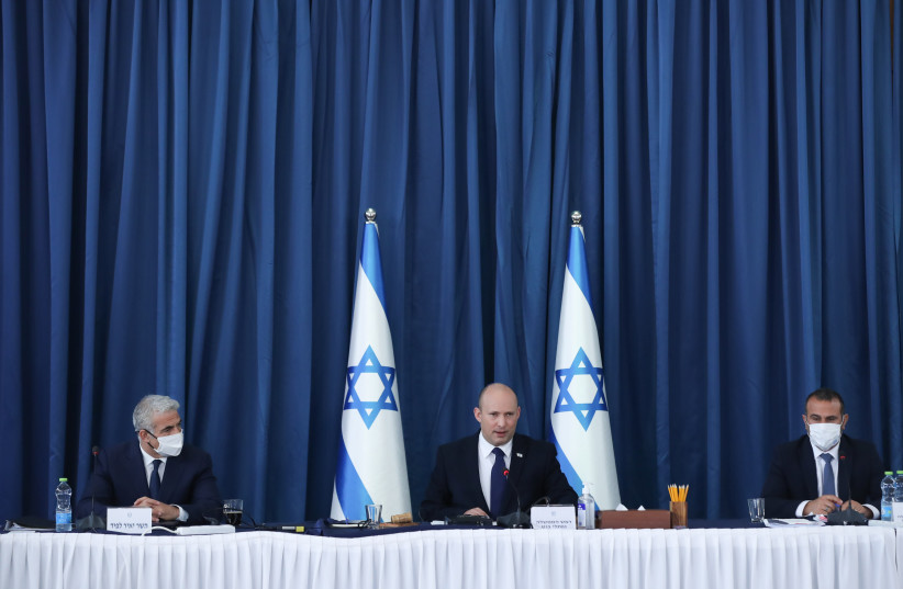 Israeli Prime Minister Naftali Bennett and Foreign Minister Yair Lapid (L) during a cabinet meeting at the Foreign Ministry in Jerusalem on August 8, 2021. (credit: OHAD TZVEIGENBERG‏/POOL)
