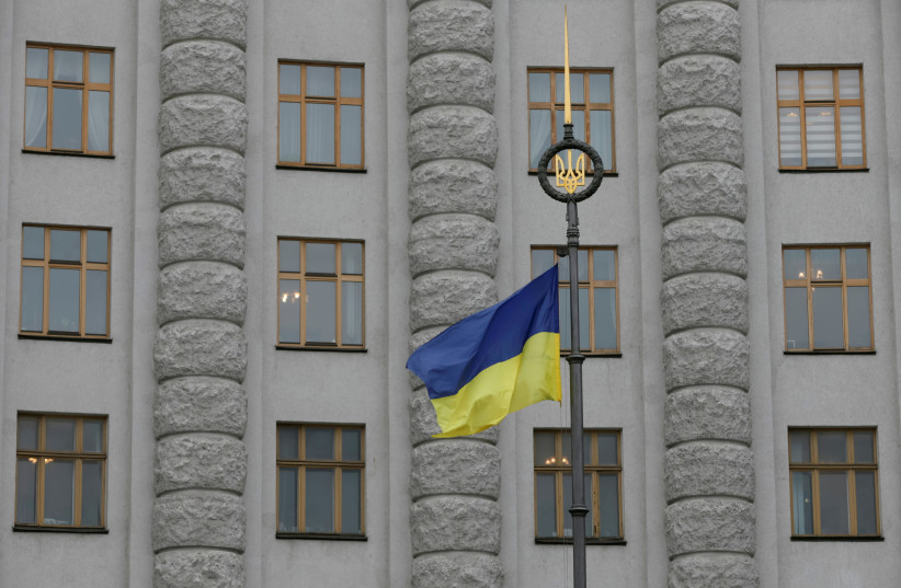 A Ukrainian national flag flies in front of government building in central Kiev (photo credit: REUTERS)