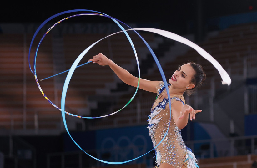 ISRAEL'S LINOY ASHRAM performs in the ribbon component of the women's all-around rhythmic gymnastics finals competition on Saturday. The 22-year-old Israeli captured the gold medal, the first blue-and-white female Olympian to stand atop the podium. (credit: REUTERS)