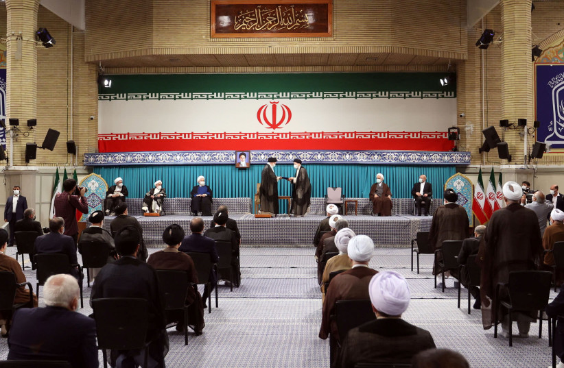 Iran's new President Ebrahim Raisi receives the endorsement decree for his presidency from Iran's Supreme Leader Ayatollah Ali Khamenei, in Tehran (photo credit: REUTERS)