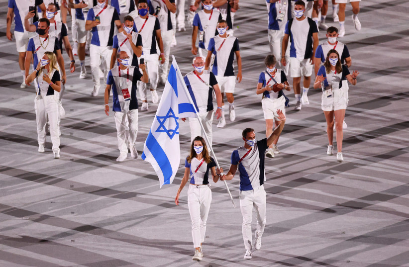 HANNA MINENKO and Yaakov Toumarkin lead the Israeli delegation of athletes at the opening of the Tokyo Olympics, in which the country captured four medals. (credit: REUTERS)