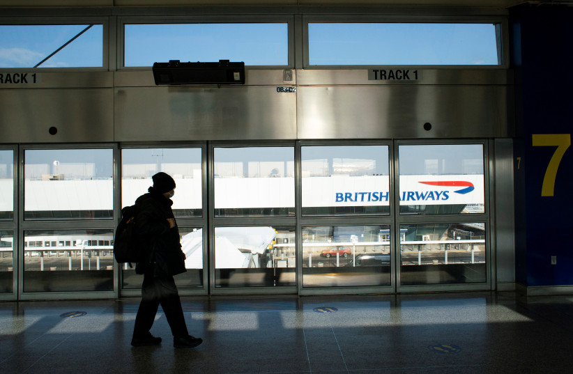  A man walks near the British Airways terminal amid new restrictions to prevent the spread of coronavirus disease (COVID-19) at JFK International Airport in New York City, US, December 21, 2020. (credit: REUTERS/EDUARDO MUNOZ)