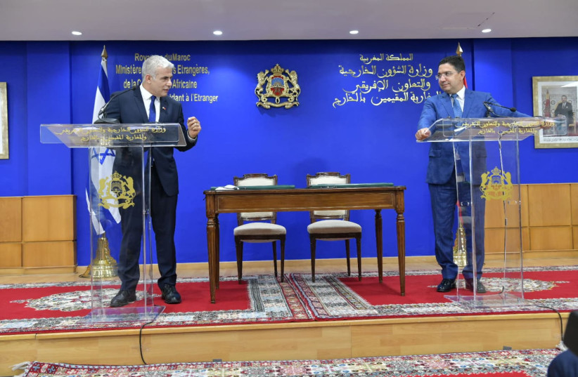   Foreign Minister Yair Lapid with Moroccan Foreign Minister Nasser Bourita at the foreign ministry in Rabat, Morocco, August 11, 2021.  (credit: SHLOMI AMSALEM/GPO)